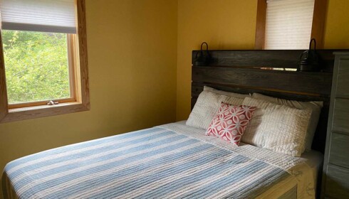 Cabin #2 Queen Bedroom comfortable queen bed with rustic headboard