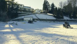 snowmobiles head out from the resort to ride the nearby trails